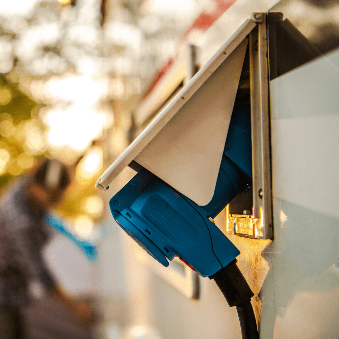 RV utility hookup station at Galloping Snail RV Park with a power connection, set against a scenic outdoor backdrop.